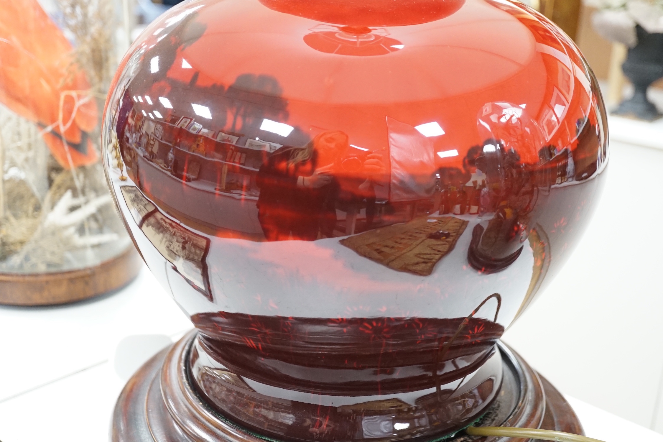 A large Royal Doulton flambe vase, approximately 30.5 cm high excluding all later fittings, mounted as a lamp with shade and associate wood stand.